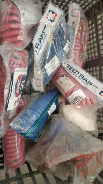 Mixed lot of new/used automotive & heavy-truck parts including air brake coiled hoses (blue/red), amber warning lights, interior armrests, and assorted filters & hardware - Image 2