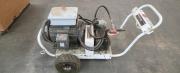 Portable industrial electric power washer/pump unit on wheeled cart with heavy-duty hoses, fittings, and 60A Cooper Arktite plug-