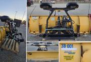 Fisher snowplow blade assembly with black mounting frame and hydraulic/electrical components.